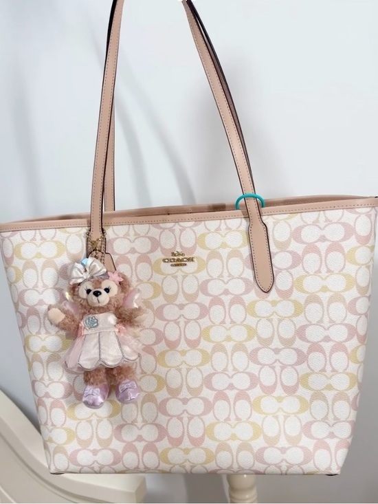 Coach Handbags - Coach Pink and Cream Signature Canvas Tote with Bear Charm